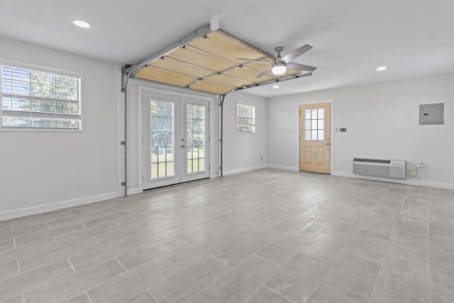 unfurnished room featuring electric panel, baseboards, ceiling fan, a wall mounted air conditioner, and recessed lighting