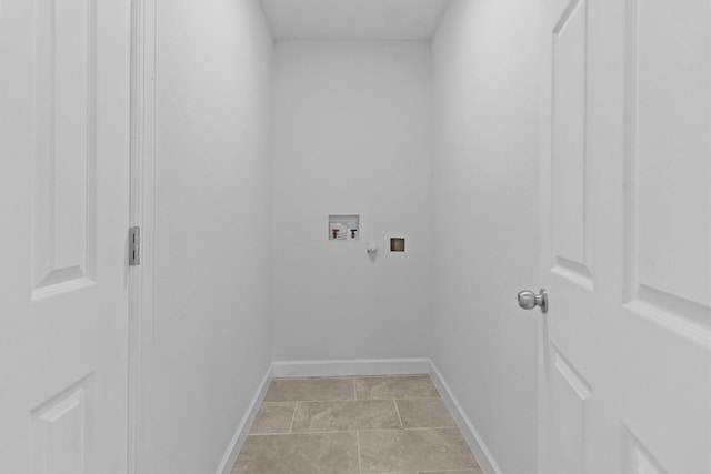 washroom featuring hookup for a washing machine, laundry area, baseboards, and light tile patterned floors