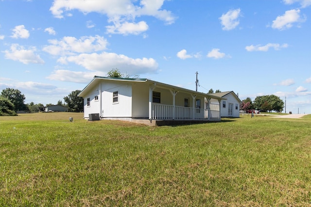 single story home with covered porch, a front lawn, and central AC unit