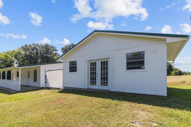 rear view of house featuring french doors and a yard