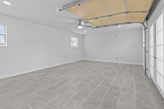 garage with ceiling fan, baseboards, and recessed lighting