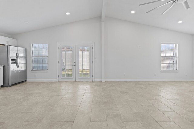 unfurnished living room with ceiling fan, high vaulted ceiling, french doors, and light tile patterned floors