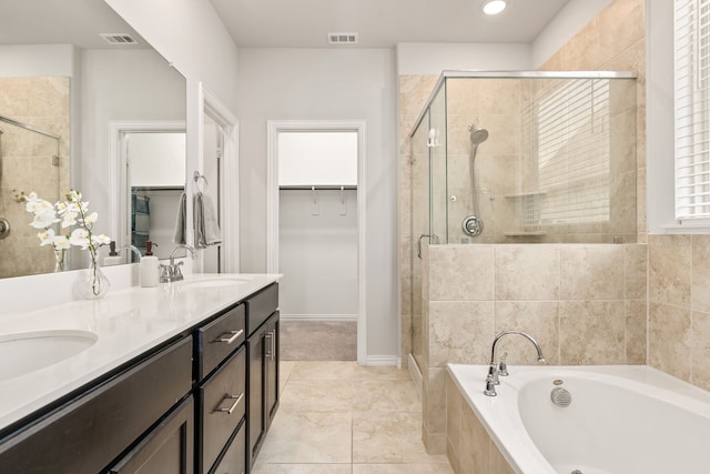 bathroom featuring vanity and shower with separate bathtub