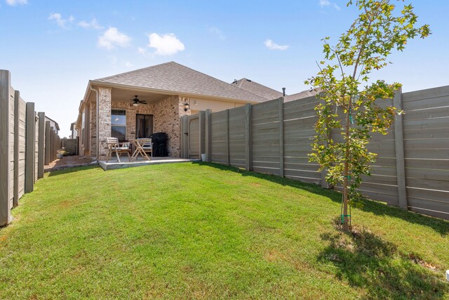 view of yard with ceiling fan and a patio area