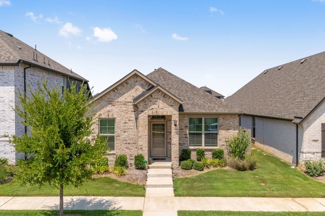 french country home with a front lawn