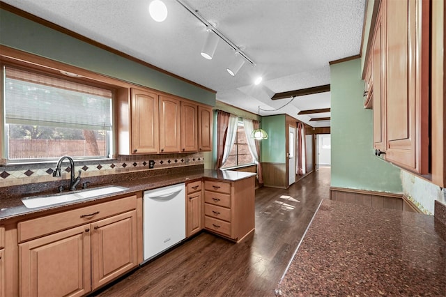 kitchen featuring sink, white dishwasher, decorative light fixtures, and a textured ceiling