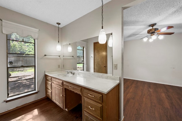 bathroom with ceiling fan, hardwood / wood-style floors, vanity, and a textured ceiling