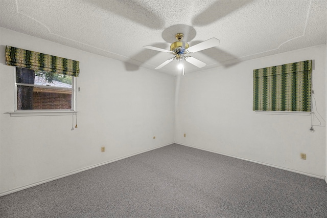 carpeted empty room featuring ceiling fan and a textured ceiling