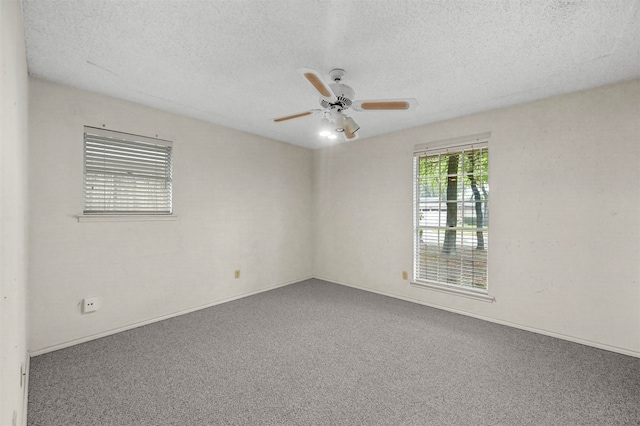 carpeted spare room featuring ceiling fan and a textured ceiling