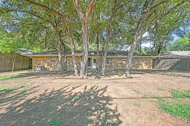 exterior space featuring cooling unit and fence