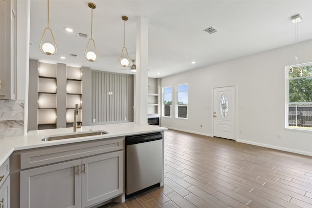 kitchen with sink, a healthy amount of sunlight, dishwasher, and gray cabinets