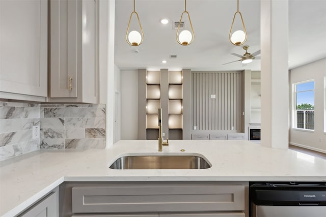 kitchen with pendant lighting, dishwasher, gray cabinets, ceiling fan, and tasteful backsplash