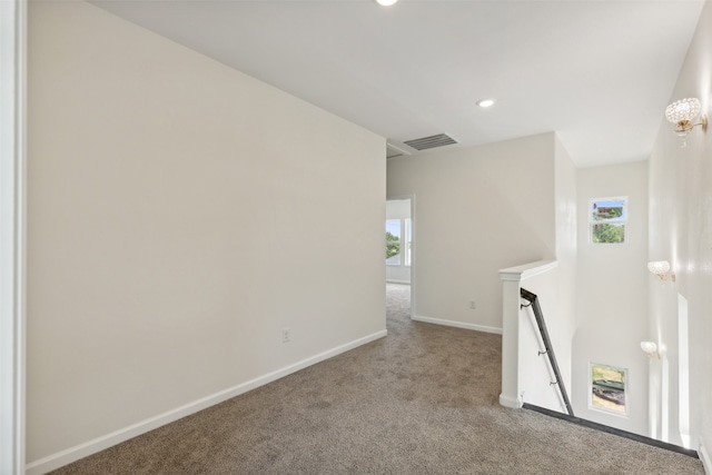 spare room featuring light colored carpet