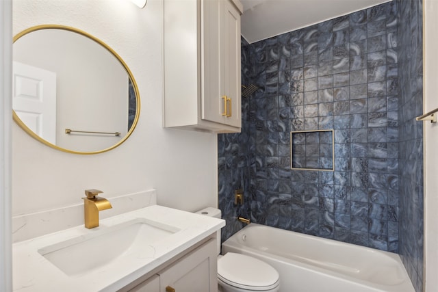 full bathroom featuring toilet, vanity, and tiled shower / bath