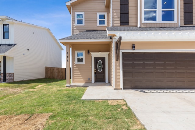 view of front of house with a front lawn and a garage