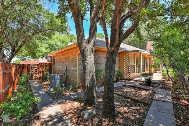 rear view of property featuring central AC unit