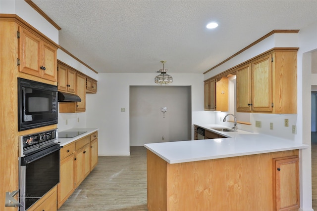 kitchen featuring a textured ceiling, sink, black appliances, light hardwood / wood-style flooring, and kitchen peninsula