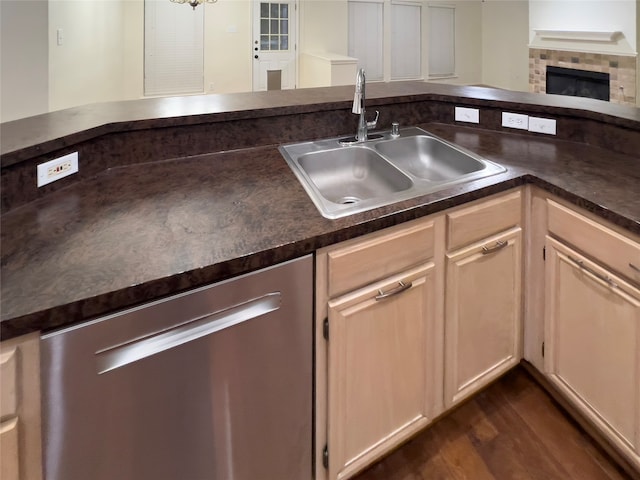 kitchen with stainless steel dishwasher, dark hardwood / wood-style floors, sink, and light brown cabinets