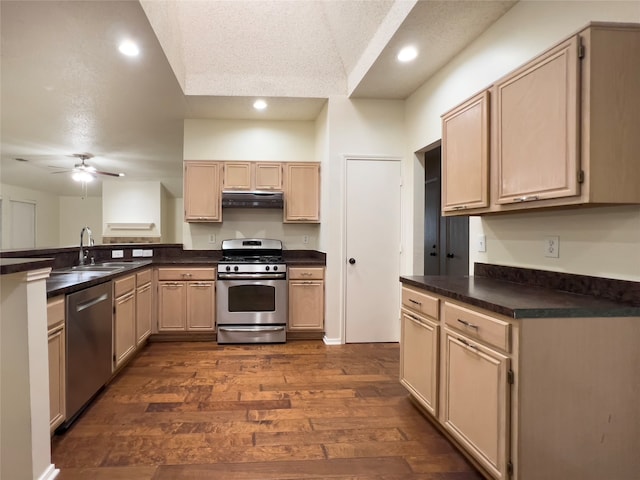 kitchen featuring stainless steel appliances, dark hardwood / wood-style flooring, ceiling fan, and light brown cabinetry