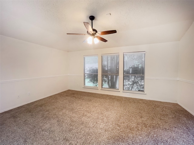 carpeted spare room featuring ceiling fan and a textured ceiling