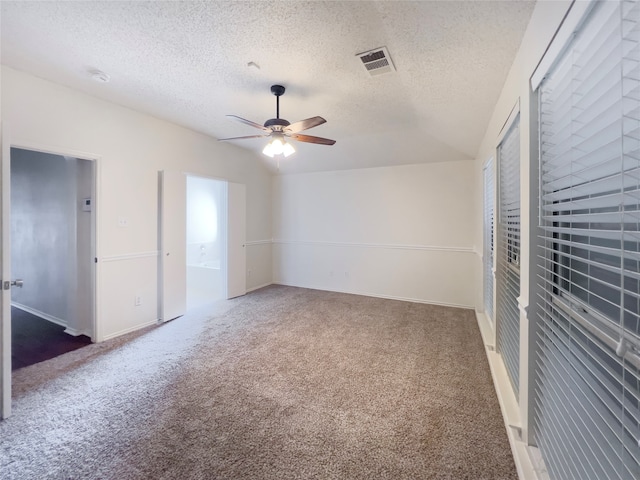 carpeted empty room with a textured ceiling and ceiling fan