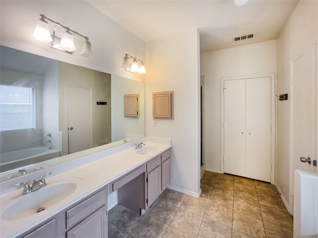 bathroom with double sink vanity, tile patterned flooring, and separate shower and tub