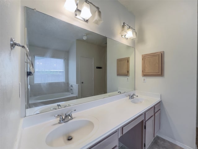 bathroom featuring dual bowl vanity and a tub to relax in