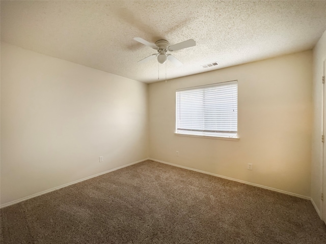 spare room featuring ceiling fan, a textured ceiling, and carpet floors