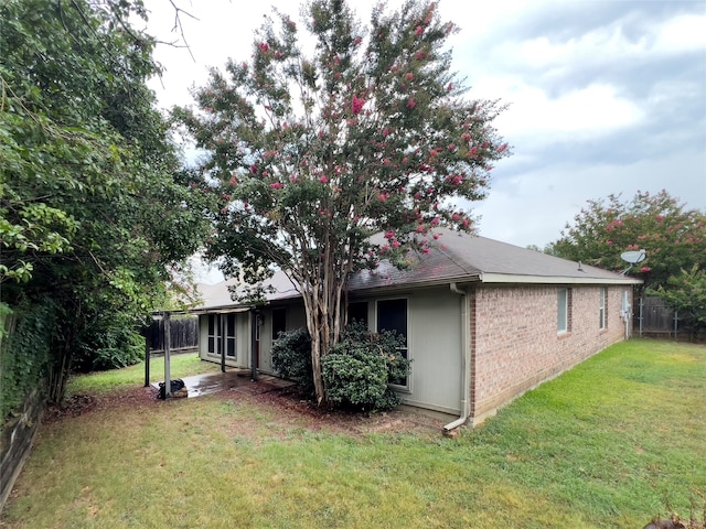 rear view of house featuring a lawn