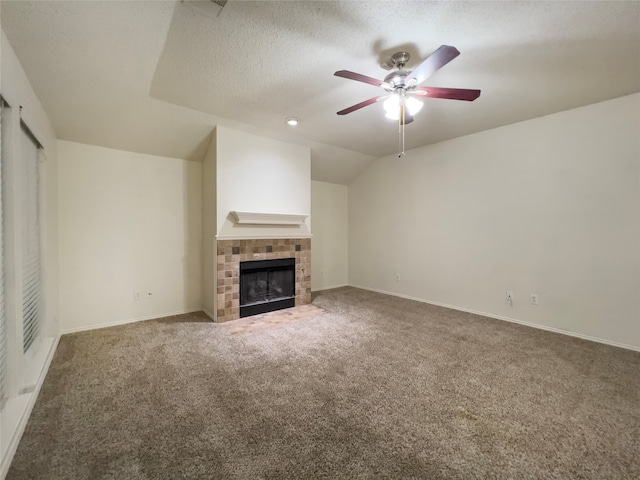 unfurnished living room with a textured ceiling, a tile fireplace, carpet flooring, and ceiling fan