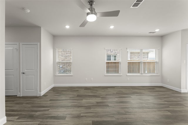 empty room with dark hardwood / wood-style floors and ceiling fan