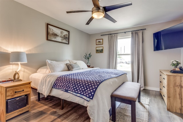 bedroom with dark hardwood / wood-style floors and ceiling fan