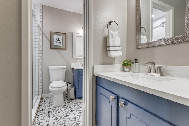 bathroom with vanity, a shower with shower door, toilet, and tile patterned floors