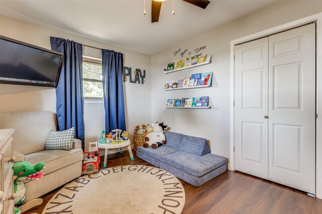 sitting room featuring ceiling fan and dark hardwood / wood-style floors