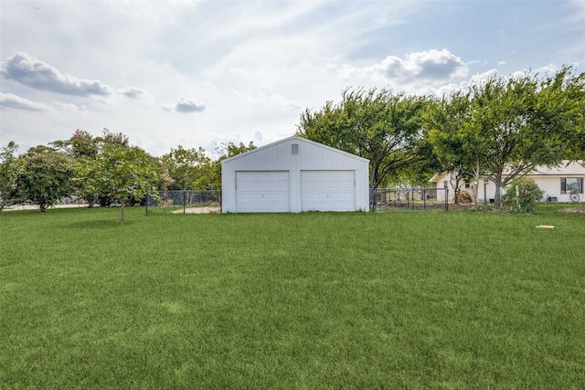 view of yard featuring an outbuilding and a garage