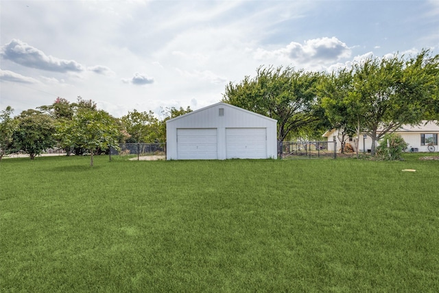 view of yard featuring a garage and an outdoor structure