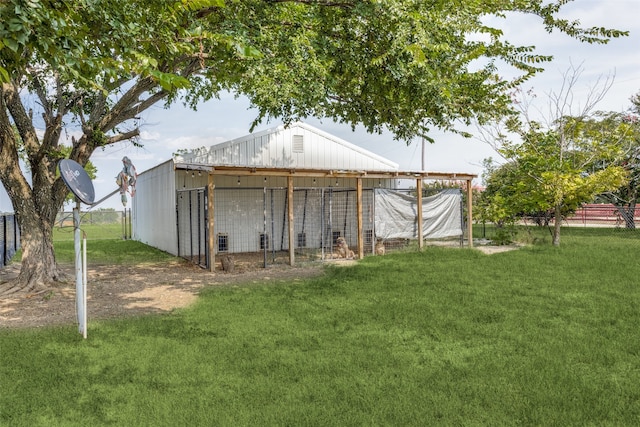 view of outdoor structure featuring a lawn