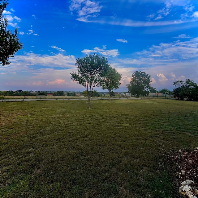 yard at dusk with a rural view