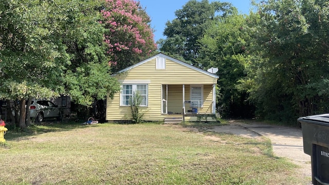 bungalow with a front lawn and a porch