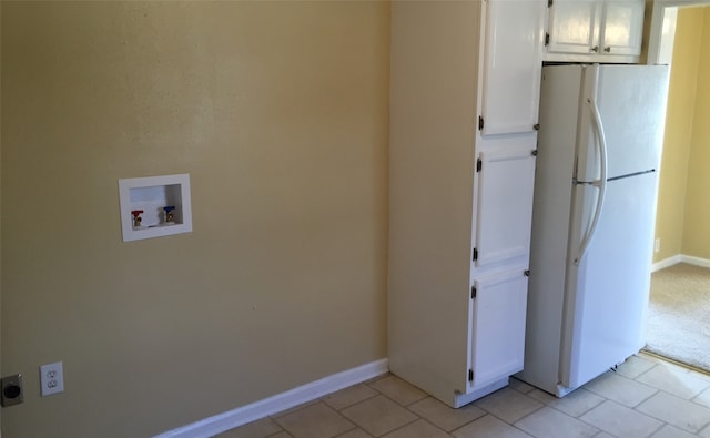 laundry area featuring hookup for an electric dryer, hookup for a washing machine, and light tile patterned floors