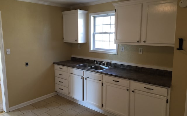 kitchen with ornamental molding, sink, white cabinetry, and light tile patterned floors