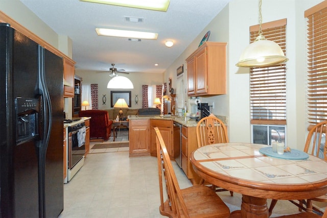 kitchen with kitchen peninsula, white gas range oven, black refrigerator with ice dispenser, ceiling fan, and hanging light fixtures