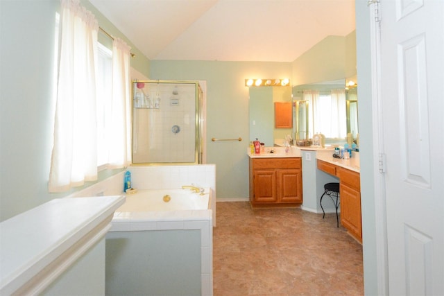 bathroom featuring separate shower and tub, vanity, and vaulted ceiling