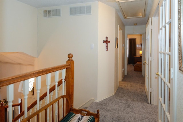 hallway featuring light colored carpet