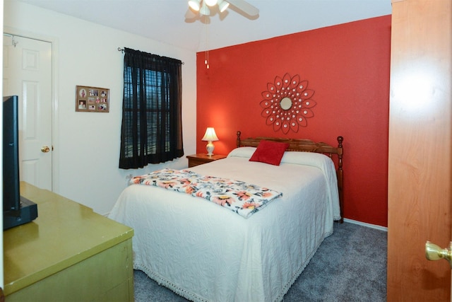 bedroom featuring dark colored carpet and ceiling fan