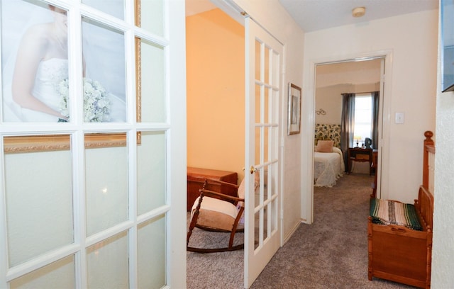 corridor with carpet flooring and french doors