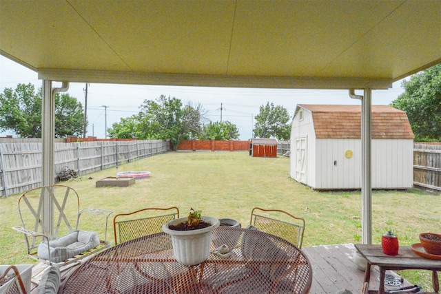 view of yard featuring a storage shed and a deck