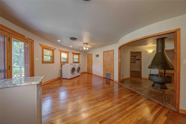 unfurnished living room featuring light hardwood / wood-style floors and washing machine and clothes dryer