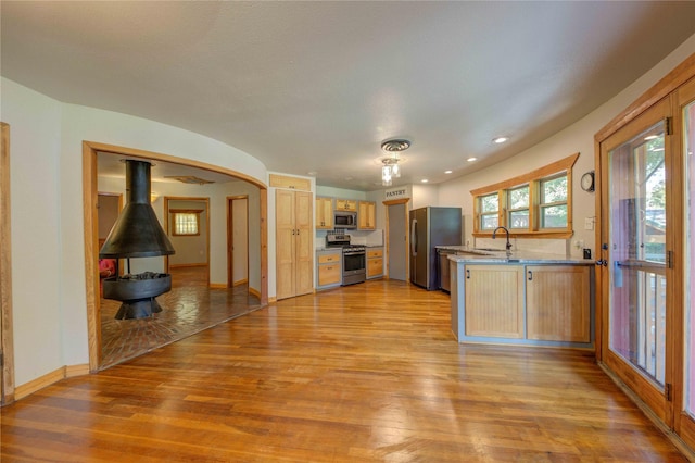 kitchen featuring sink, stainless steel appliances, light hardwood / wood-style floors, and light brown cabinets