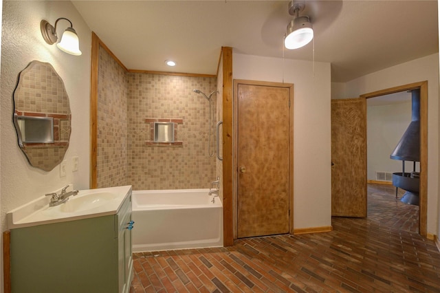 bathroom with vanity and tiled shower / bath